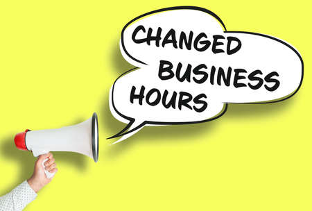 CHANGED BUSINESS HOURS poster or sign with megaphone and speech bubble against yellow backgroundの写真素材