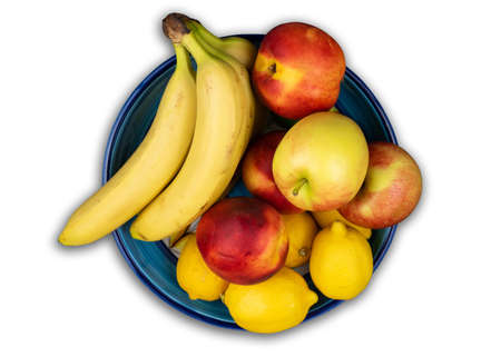 above view of fruit bowl with fresh organic bananas, apples, nectarines and lemonsの写真素材