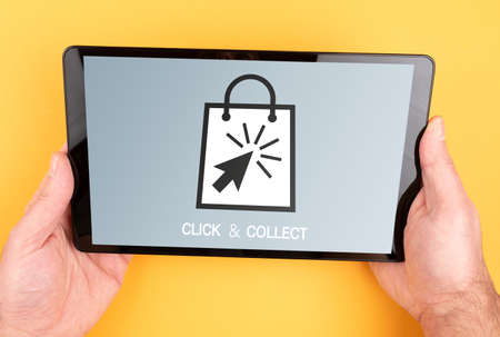 close-up view of person placing an online order using click and collect services on tablet computerの写真素材