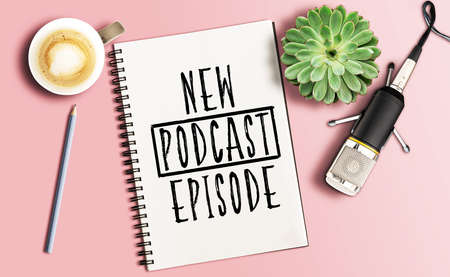 directly above shot of podcast recording equipment, microphone on desk with words new podcast episode written on note padの写真素材