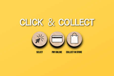 click and collect concept with symbols on round wooden discs on orange background, buying online and picking up in local storeの写真素材