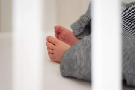 close-up of feet of neborn baby resting in crib