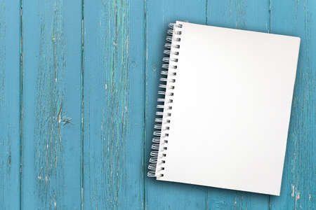 blank spiral notepad with copy space on rustic wooden table