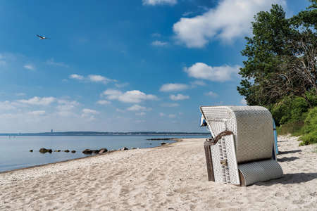 traditional canopied beach chair on beautiful baltic sea beach on sunny dayの写真素材