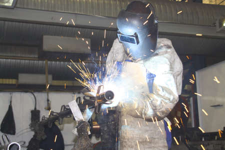 Worksman / labourer welding a metal component