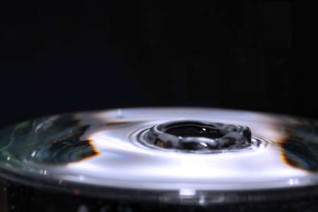 Action shot of water dropping into a glassの写真素材