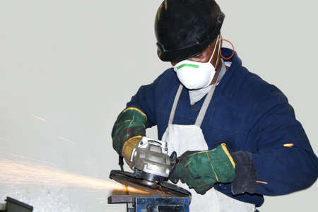 A man grinding a piece of metal