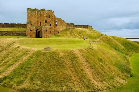 Tynemouth Priory ruins with grass filled moatの写真素材