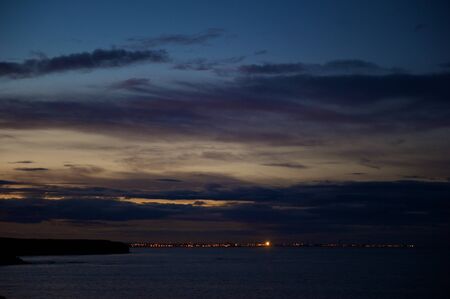 Dramatic sunset sky with multiple colours over Blyth, Northumberland, UKの写真素材