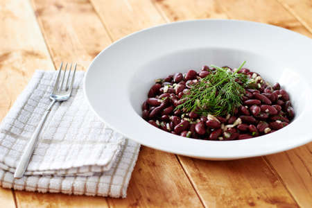 Kidney beans with spring onion on a wooden tableの写真素材
