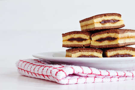 Cakes with cocoa on wooden tableの写真素材