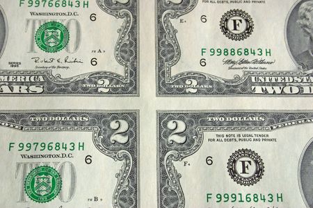 Close up of corners of 4 bills in a sheet of two dollar bills