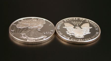 Two American Eagle Silver Bullion Coins (legal tender) showing the front and back of the coin