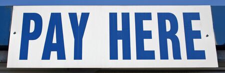 A blue and white sign that reads Pay Hereの写真素材