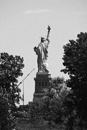 A black and white image of the Statue of Liberty from the backの写真素材