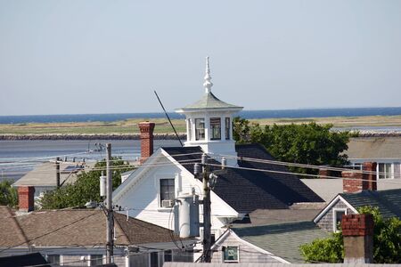 A pretty cupola with the coastline of Provincetown, Massachusetts in the background