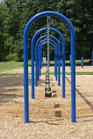 A blue swingset in a neighborhood park