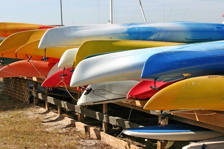 Several rows of pretty, brightly colored canoesの写真素材