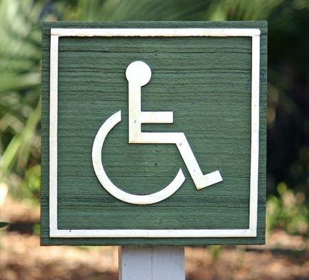 A green wooden Handicapped sign in a parkの写真素材
