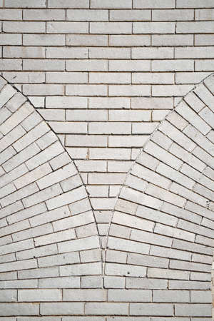 A white decorative brick wall with a curved patternの写真素材