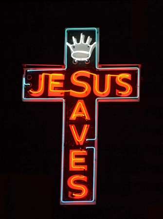 A red neon sign reading Jesus Savesの写真素材