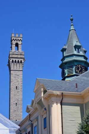 A view of the town hall spire and the Pilgrim Monument in Provincetown, Massachusettsの写真素材