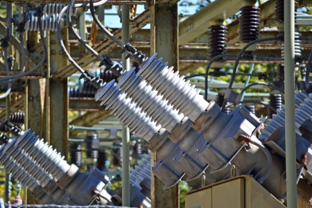 A view of a high voltage substation with switches and insulatorsの写真素材