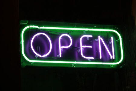 An open sign in the window of a retail establishment
