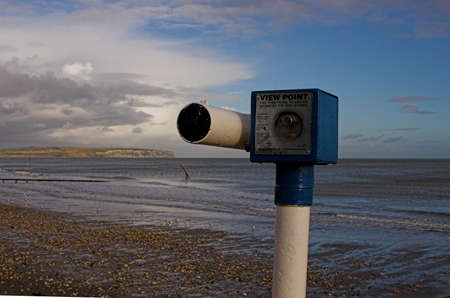 Seaside viewing telescope overlooking sea.