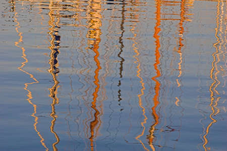 Boat mast reflections in sea.の写真素材