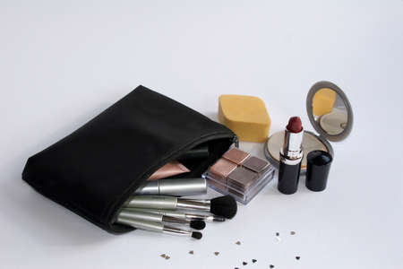 Black make up bag with assorted brushes lipstick,mirror & spongeの写真素材