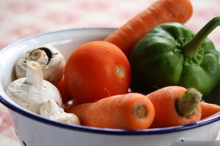 mushrooms,carrots,pepper and tomato in colander close-up