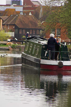 narrow boat on river with housesの写真素材