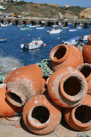 Fishing pots in terracotta with sea behindの写真素材
