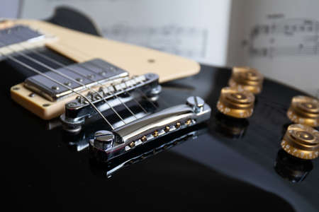black Electric guitar body with silver pickups , chrome bridge and gold control knobsの写真素材