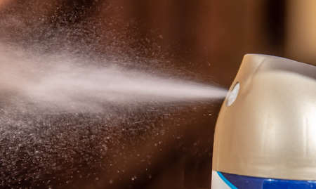 aerosol can sprays air freshener scent into a roomの写真素材