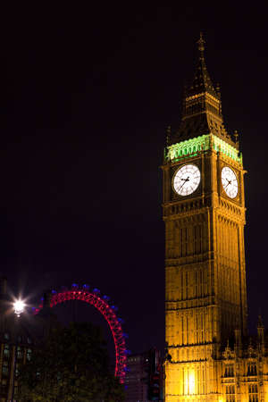 Big Ben (Houses of Parliament) in London.  The London Eye is in the background.のeditorial素材