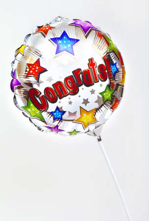 A 'Congratulations' balloon over a plain background.の写真素材