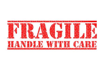 FRAGILE - HANDLE WITH CARE red rubber stamp over a white background.の写真素材
