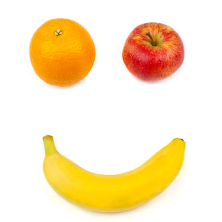 Three different pieces of fruit making up a smiling face over a white background.の写真素材