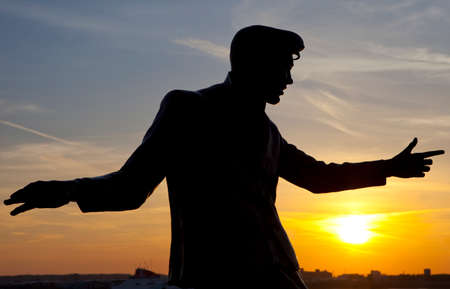 The silhouette of a statue dedicated to legendary British singer Billy Fury located on the Albert Dock in Liverpool のeditorial素材