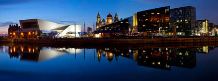 The beautiful panoramic view of the Liverpool Pier Head taken from the Albert Dock.  The view takes in sights including the Museum of Liverpool, the Royal Liver building, the Port of Liverpool building and Mann Island.のeditorial素材