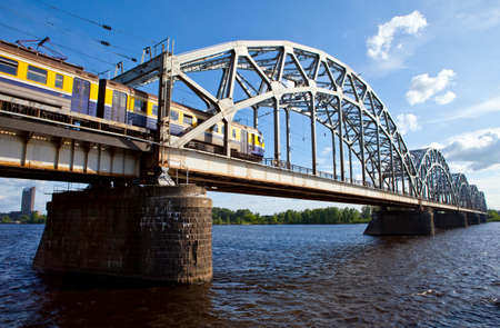 A train traveling across the Iron Bridge over the Daugava River in Riga, Latvia 