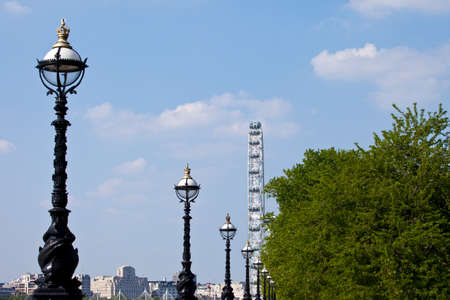 LONDON, UK - MAY 18TH 2014: The vintage street lamps along the Albert Embankment and the London Eye on 18th May 2014.のeditorial素材
