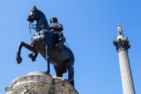 The statue of King Charles 1st with the magnificent Nelsons Column in the background in Trafalgar Square, London.のeditorial素材