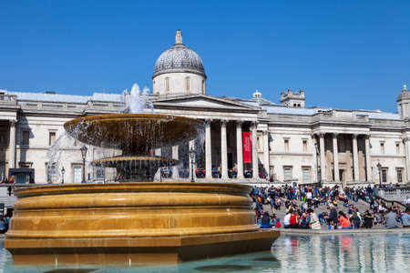LONDON, UK - APRIL 7TH 2015: A view of one of the fountains in Trafalgar Square with the National Gallery in the background, in London on 7th April 2015.のeditorial素材