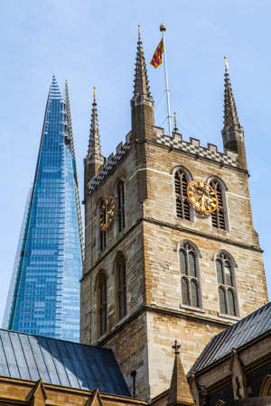 The tower of Southwark Cathedral with the Shard skyscraper behind in London.のeditorial素材