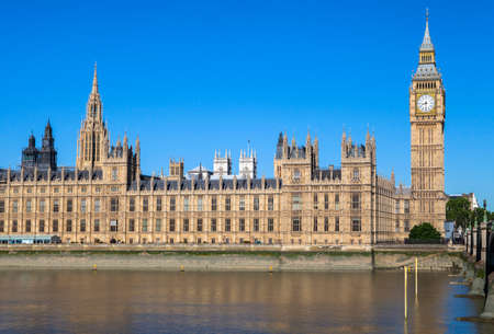 A view of the magnificent Palace of Westminster over the River Thames in London.  The towers of Westminster Abbey can be seen in the distance.のeditorial素材