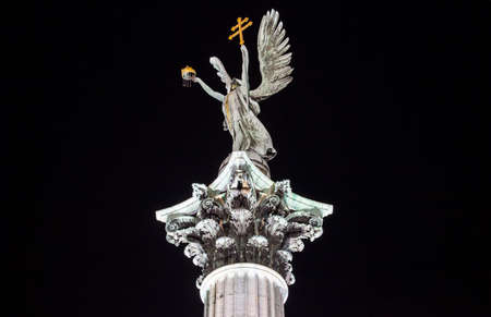 A night-time view of the sculpture on top of the column at Heroes Square in Budapest.の写真素材
