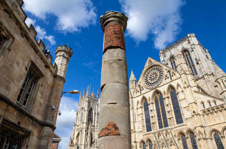The historic Roman Column with York Minster in the background in York, England.の写真素材